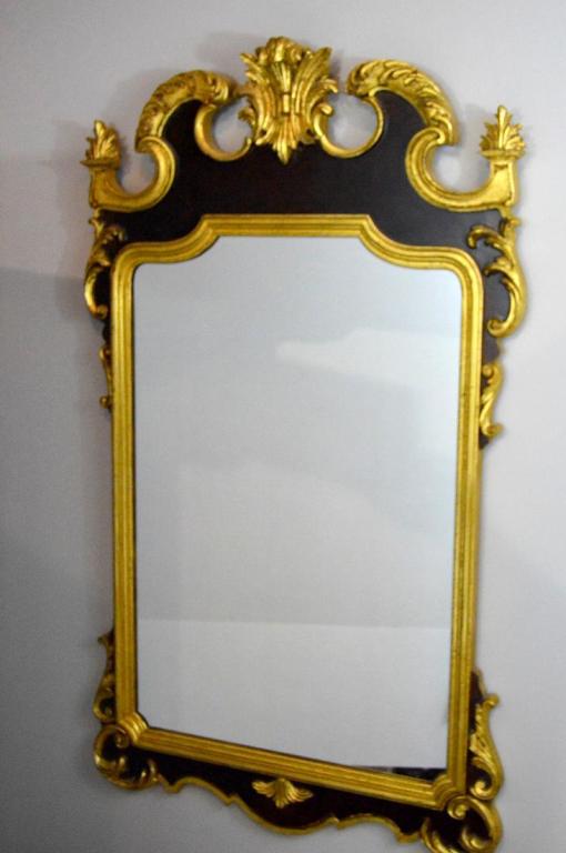 George III Style Gilt Wood Mirror: With giltwood and veneer pediment over a shaped glass 47 x 27 x 2 in.