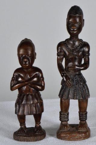 Two African Wooden Statues: The larger man is dressed in a necklace and the smaller man has his arms crossed looking down 9 x 2 in.; 7 x 2 in. Condition: No apparent flaws or nicks. Property of Anthony French. Sr.
