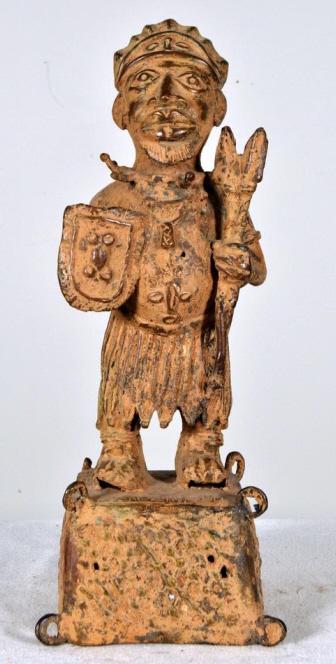 Benin Bronze of a Royal Figure: Benin, West Africa, bronze; Of a warrior carrying a shield and spears with a integral base. 17 x 6 x 6 in. Condition: Wear consistent with age and use Property of Anthony French. Sr.