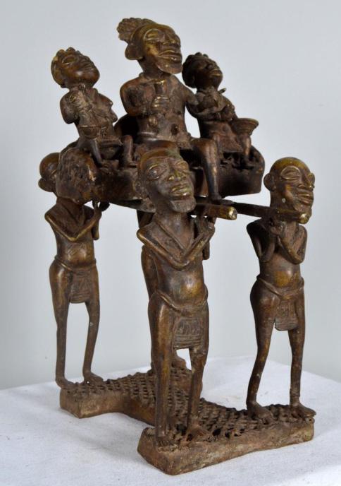 Benin Bronze of a Royal Procession: Benin, Bronze, West African; Of a Royal person attended by two women and carried in a litter by four bearers 19 x 10 x 9 in.; Condition: Wear consistent with age and use Property of Anthony French. Sr
