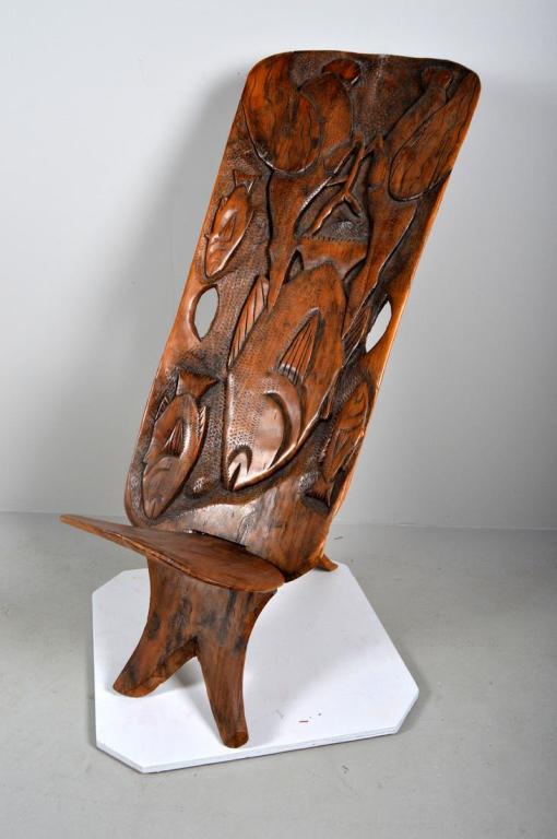 Palaver Chair, Ivory Coast, 20th Century: The back carved with fish and water fowl. 45 x 18 x 24 in. Condition: Wear consistent with age and use Property of Anthony French. Sr.