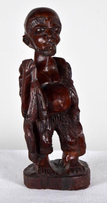 Modern African Statue of Man: Of a man standing, holding a basket and a bag over his shoulder 15 x 5.5 x 5 in. Condition: Wear consistent with age and use Property of Anthony French. Sr.