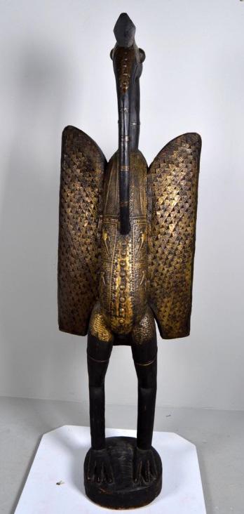 Senofu Bird (Hornbill) Statue: African, Mali/Ivory Coast, wood, 20th Century; Of a standing bird (hornbill), embellished with applied metal decorations. 58 x 18 x 10 in. Condition: Wear consistent with age and use Property of Antho