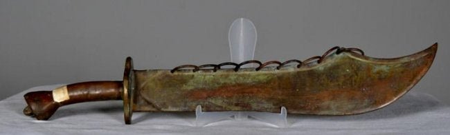 Western African Bronze Sword: The sword has nine bronze rings attached from the top to bottom of blade and the handle is smooth . 27 x 5 in. Condition: Wear consistent with age and use Property of Anthony French. Sr.