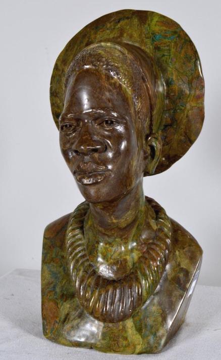 Nicholas Tandi (Zimbabwe, 1948): Shona Female Verdite Hand-carved bust of a woman with necklace and headdress Carved signature on side 18 x 12 x 9 in. Condition: Wear consistent with age and use Property of Anthony French. Sr.