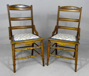 Pair of Eastlake Side Chairs: Each with shaped and moulded crestrail over two ladder splats with plain seat the whole raised on turned legs supported by turned stretchers. 35 x 16 x 16 in.