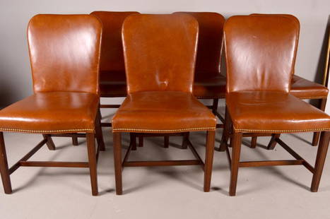 Six George III Style Leather Side Chairs: Each chair is covered with tan leather throughout the front and back continuing on to the seat in the same leather with brass studs surrounding the seat. Resting on slightly tapered legs to the front