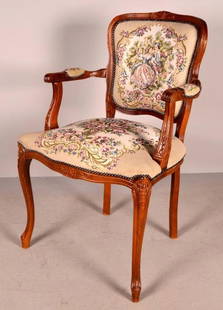Louis XV Style Armchair: 20th Century, with shaped and rounded rectangular back over a upholstered seat flanked by carved and molded arms and shaped stumps, the whole raised on carved cabriole legs. 36 x 24 x 20 in.