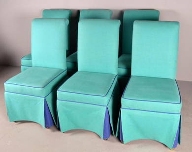 Six Linen Upholstered Dining Chairs: Each upholstered in turquoise linen, with rectangular back and seat, raised on four square legs on rollers and covered with a skirt. each 39 x 19 x 20 in. NOTE: Slight staining to fabric on three
