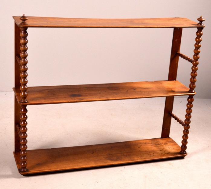 Breton Wall Shelf: Three shelves supported by turned stretchers. 25 x 31 x 8 in. NOTE: Wear consistent with age and use.