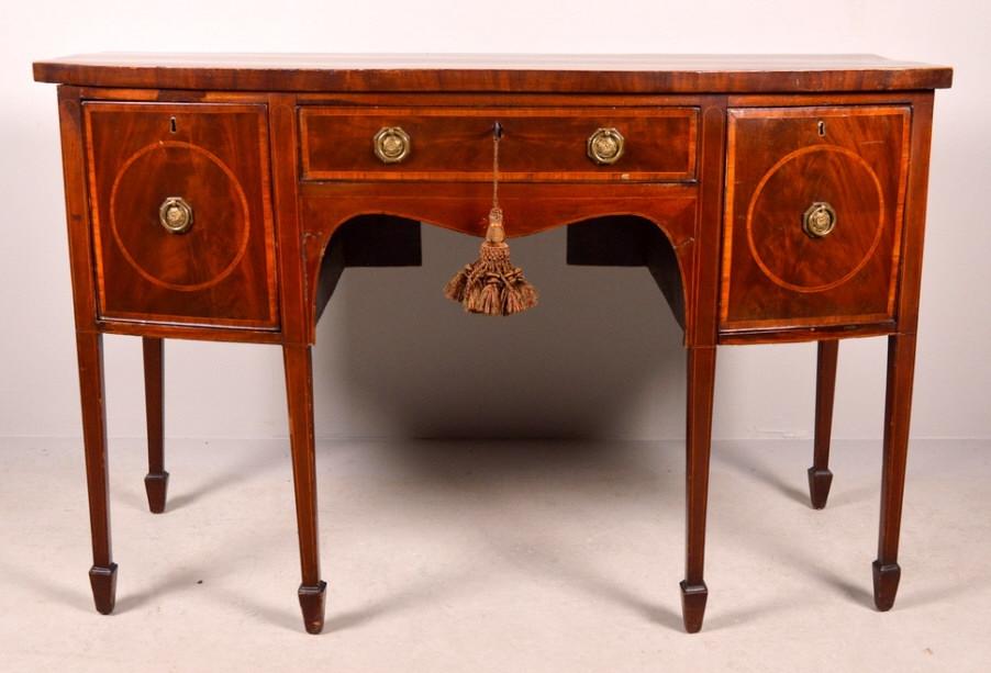 George III Inlaid Mahogany Sideboard: Of diminutive size, with a shaped and banded top over a single drawer flanked by two bottle drawers, each drawer inlaid with fruitwood, the whole raised on six tapering square legs ending in spade fee