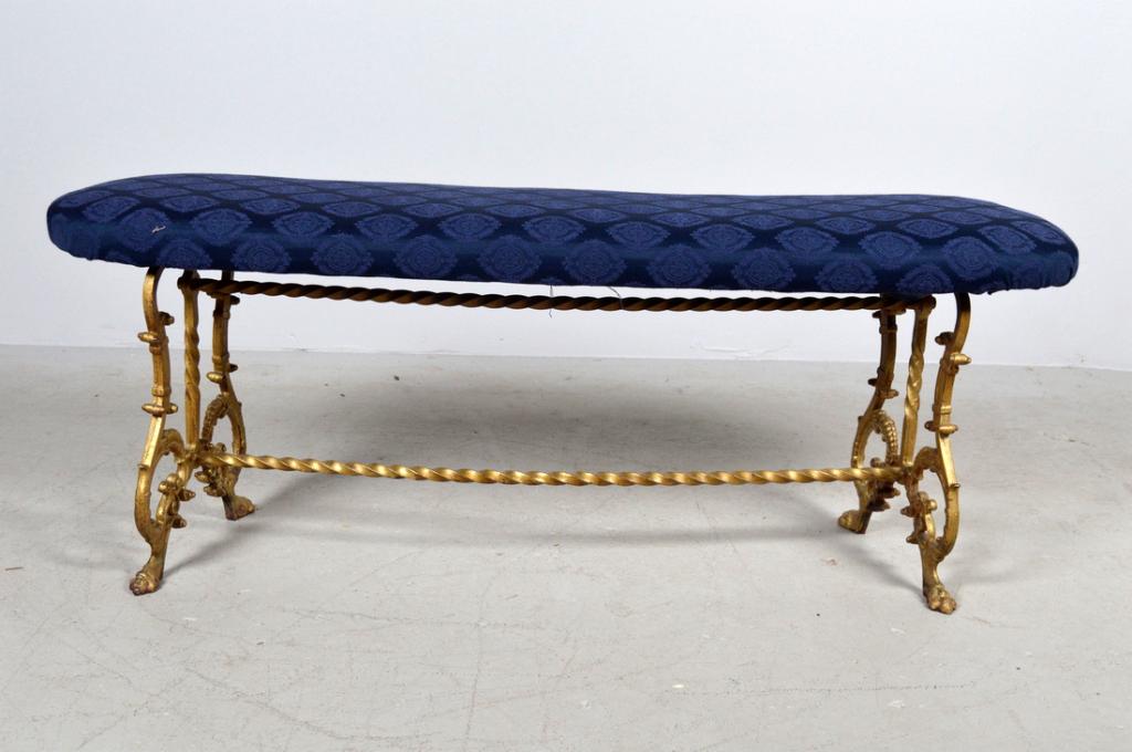 Upholstered Bench: With a shaped and upholstered seat raised on a pair of legs comprised of rocailles supported by a stretcher. 18 x 48 x 13 in. NOTE: Wear consistent with age and use