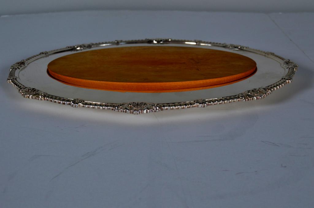 Alex Clark and Company Platter: The oval serving dish has an inch lower ground indentation with a wood piece that fits in the oval platter and can be used as a trivet Condition is consistent with age and use. Note: marked Weeback in