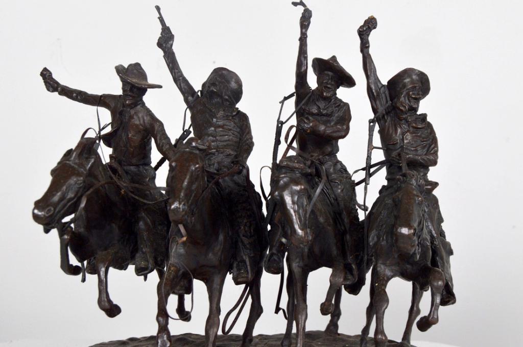 After Frederic Remington (American, 1861-1909): Coming through the Rye Bronze on a marble pedestal Inscribed in cast on work 13 x 12 x 8 in. NOTE: Generally good condition, with one gun barrel missing, two bent and one intact.