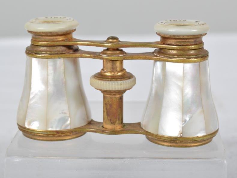 Vintage Munroy Opera Glasses: With mother of pearl veneer, and labeled "Monroy - Paris" 2.25 x 3.75 x 1.5 in. Good condition. Some tarnish to brass.