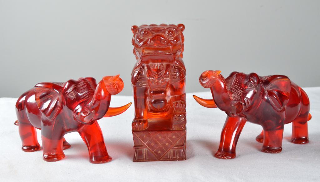 Carved Lucite Fu Dog and Pair of Elephants: Together with associated stand; Measurements for Fu DogDimensions: 9 x 3.5 x 4.5 in.NOTE: Wear consistent with age and use