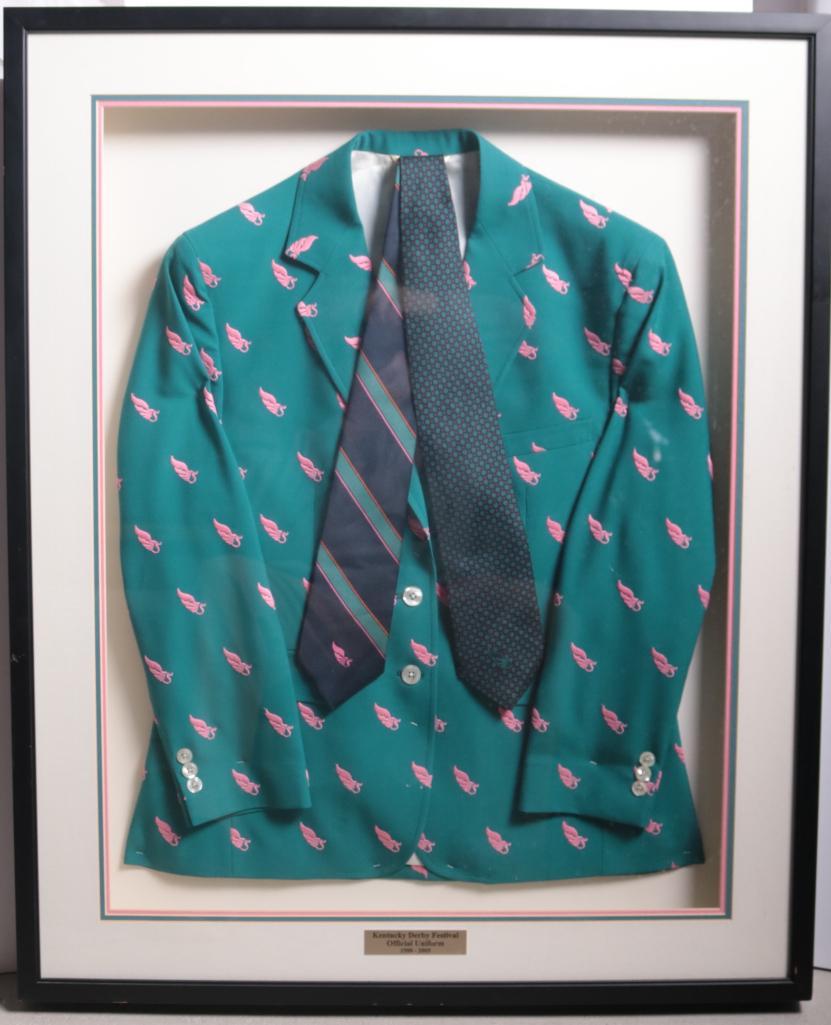 Kentucky Derby Festival Official Uniform 1988-2005: Dark green jacket with small pink pegasus pattern throughout complete with necktie Dimensions: 39 x 31 x 3 in.NOTE: Very good and in boxed in frame. Property of Anthony French Jr.