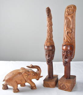 African Wood Sculpture: Three African sculptures, male and female heads with headdress and an elephant. Measurement is for male sculpture. Dimensions: 18 x 3 x 4.5 in. NOTE: No apparent flaws