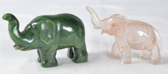 Two Carved Elephants: One of green jade, the other of quartz, both with upward facing trunks; measurements are for largest Dimensions: 2.5 x 3.5 x 1.5 in. NOTE: Wear consistent with age and use