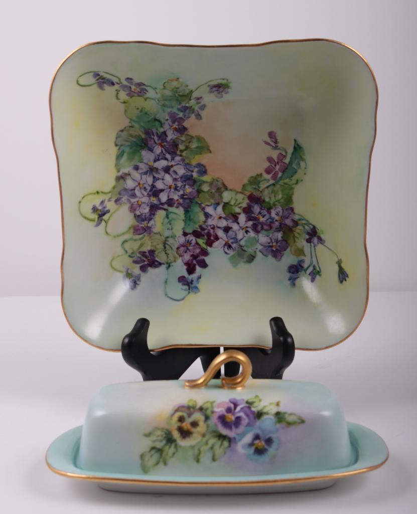 Bareuther Bowl and Butter Dish with Lid: Iris flowers throughout shallow bowl on green ground, butter dish has Iris flowers on the lid with gold handle Dimensions: 8 x 8 x 2 in. NOTE: No apparent flaws