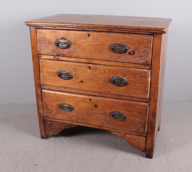 19th C. Pine Chest of Drawers: Early country pine chest having three drawers with brass oval bail pulls, on bracket feet. Dimensions: 32 x 32 x 18 in. NOTE: Wear consistent with age