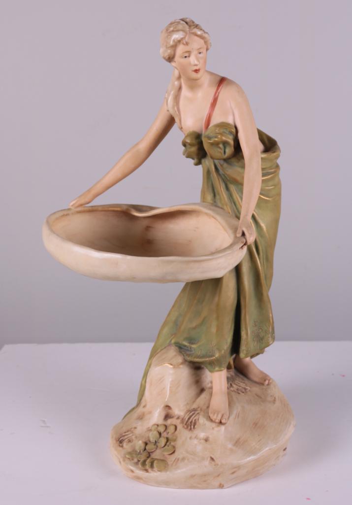 Royal Dux, Bohemia #1128 Maiden Figurine: Manufactured between 1890 and 1919 by Dux Porcelain Manufactory, matte finish figurine of a maiden with large vessel. Marked with unglazed bisque triangle and "E", and item number 1128. Dimens