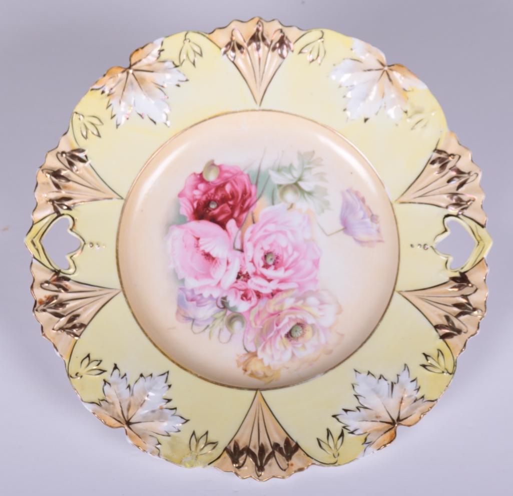 RS Prussia Cake Plate: Marked on base, with molded rim, floral decoration on plate Dimensions: 1.5 x 11 x 11 in. NOTE: Good Condition: No chips, cracks or repairs