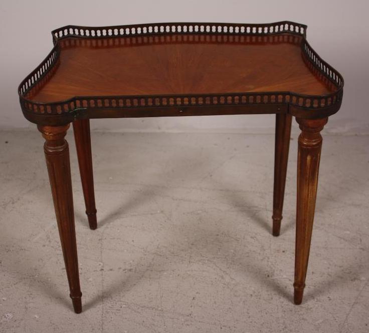 Louis XVI Style Side Table: With a galleried top, the whole raised on four fluted turned legs Dimensions: 16 x 18 x 11 in. NOTE: Wear consistent with age and use
