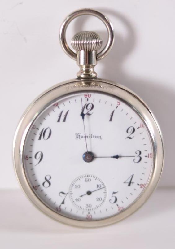 1898 Hamilton 15 Jewel Railroad Pocket Watch: Size 18s, Serial #26794, Grade 928, inscribed "Wilson Bros | Greenfield, O." on works. Silver body with front and back crystals. In working order. 2 in. Diameter