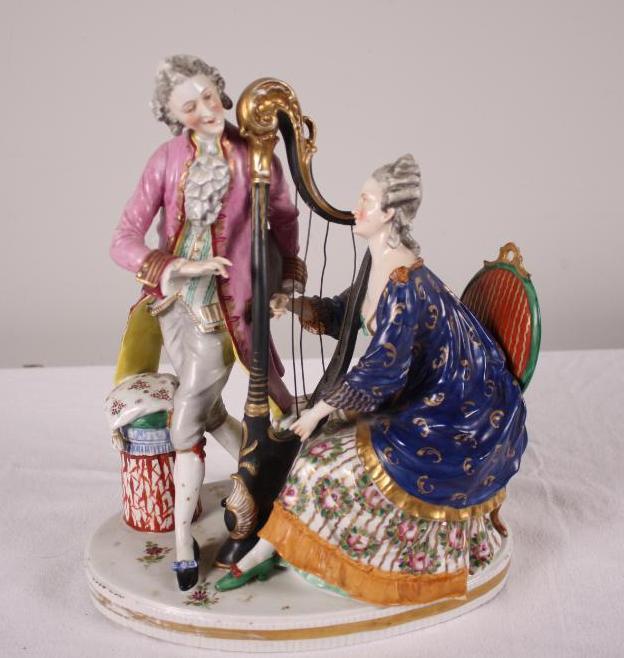 19th Century Chelsea Porcelain Figurine of A Man and Woman: The woman at the harp. No apparent marks Dimensions: 13 x 11 x 6 in. NOTE: Wear consistent with age and use