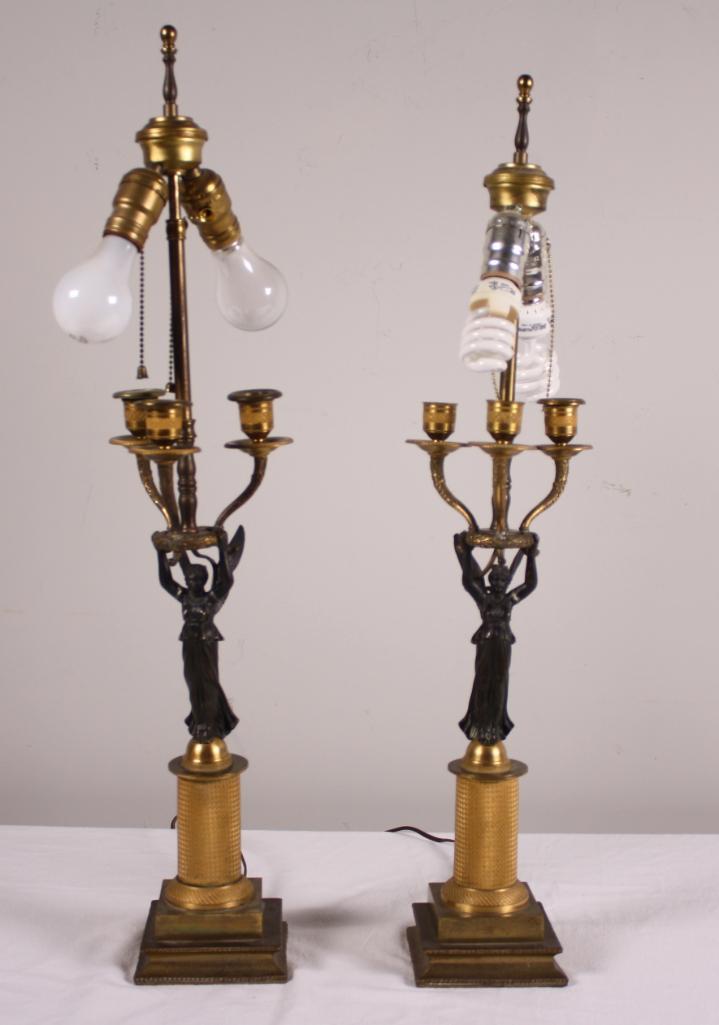 Pair of Empire Brass Lamps: Each with with a winged Liberty Figure Dimensions: 28 x 7 x 7 in. NOTE: Wear consistent with age and use