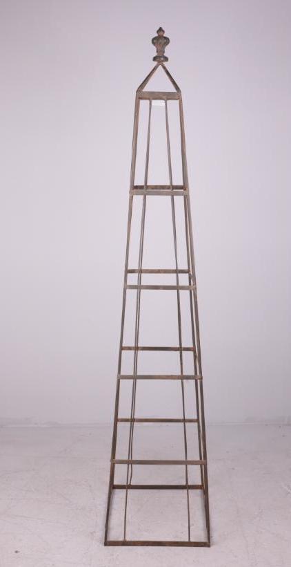 Wire Plant Obelisk: Welded wire obelisk with urn finial. Dimensions: 54 x 11 x 11 in. NOTE: Some weathering