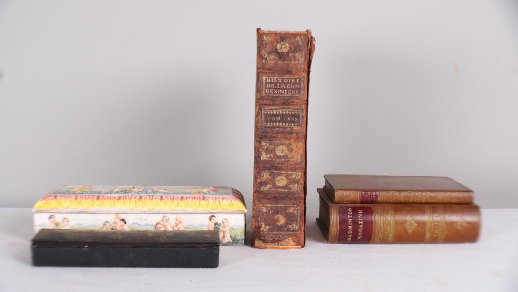 Collection of Decorative Boxes: A pair of faux book boxes, a black lacquer pen box and a porcelain pen box Dimensions: x x in. NOTE: