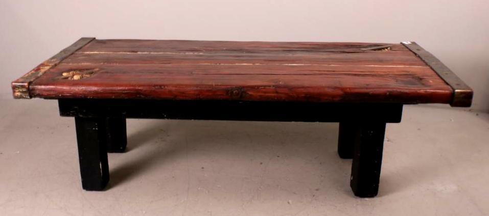 Wooden Nautical Coffee Table: With a paneled wooden top with brass fittings, on a later wooden base Dimensions: 20 x 60 x 26.75 in.