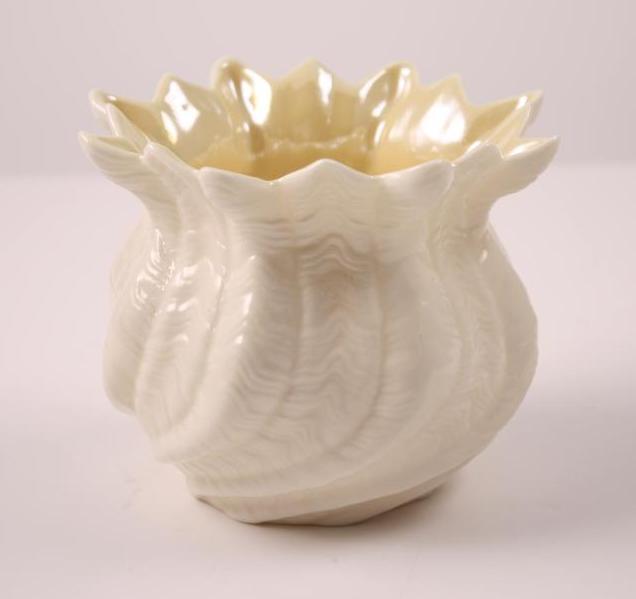 Beleek Ireland Opaline Porcelain Bowl: Of naturalistic form, with an opaline interior. Dimensions: H 4 x W 5 x D 5 inches NOTE: No evidence of repairs, chips or cracks