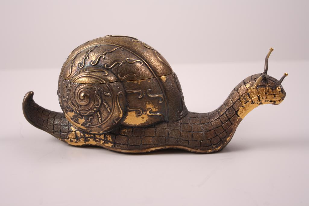 Brass Box in Form of a Snail: In the form of a moving snail, shell opening to reveal boxDimensions: H 4 x W 9 x D 4 inchesNOTE: Wear consistent with age and use