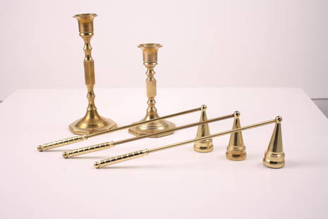 A Grouping of Brass Items: Including two candlesticks and three brass snuffers. Snuffers are 10 inches longDimensions: H 2 x W 2 x D 10 inchesNOTE: Wear consistent with age and use