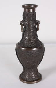 Small Chased Metal Urn: Of usual form, chased with flowers Dimensions: H 9 x W 3.5 x D 3.5 inches NOTE: Good condition Property from the Estate of Bill Ford, Paducah, KY