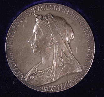 1897 Queen Victoria Silver Jubilee Medal: In a red presentation box. Dimensions: H 1 x W 3.5 x D 3.5 inchesNOTE: Box shows wear. Property from the Estate of Bill Ford, Paducah, KY