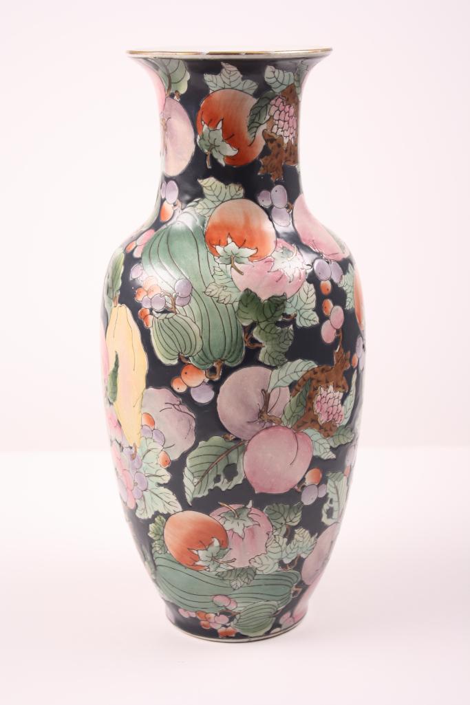 Floral Chinese Vase, 20th C: Of usual form, decorated with fruit and foliage on a black ground. Dimensions: H 13 x W 5.5 x D 5.5 inches NOTE: Wear consistent with age and use