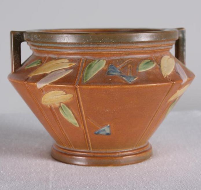Roseville Pottery Futura Jardiniere: Brown ground, unmarked. Dimensions: H 6 x W 9.5 x D 9.5 inches NOTE: No evidence of cracks, chips or repairs
