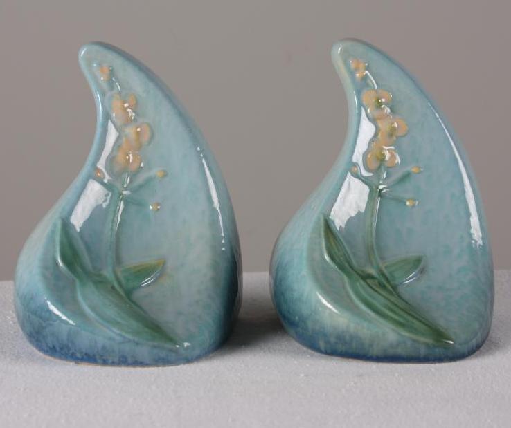 Roseville Pottery Windcraft Bookends: Blue ground, each marked 259 on base. Dimensions: H 6.5 x W 5 x D 5 inches NOTE: No evidence of cracks, chips or repairs