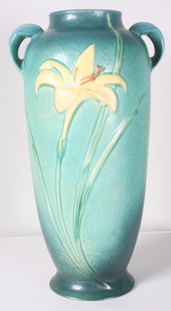Roseville Pottery Zephyr Lily Floor Vase: The handled vase has large yellow and pink lilies are on green ground. 142-18 marked on base Dimensions: H 18 x W 10 x D 10 inches NOTE: No apparent chips, cracks or repairs