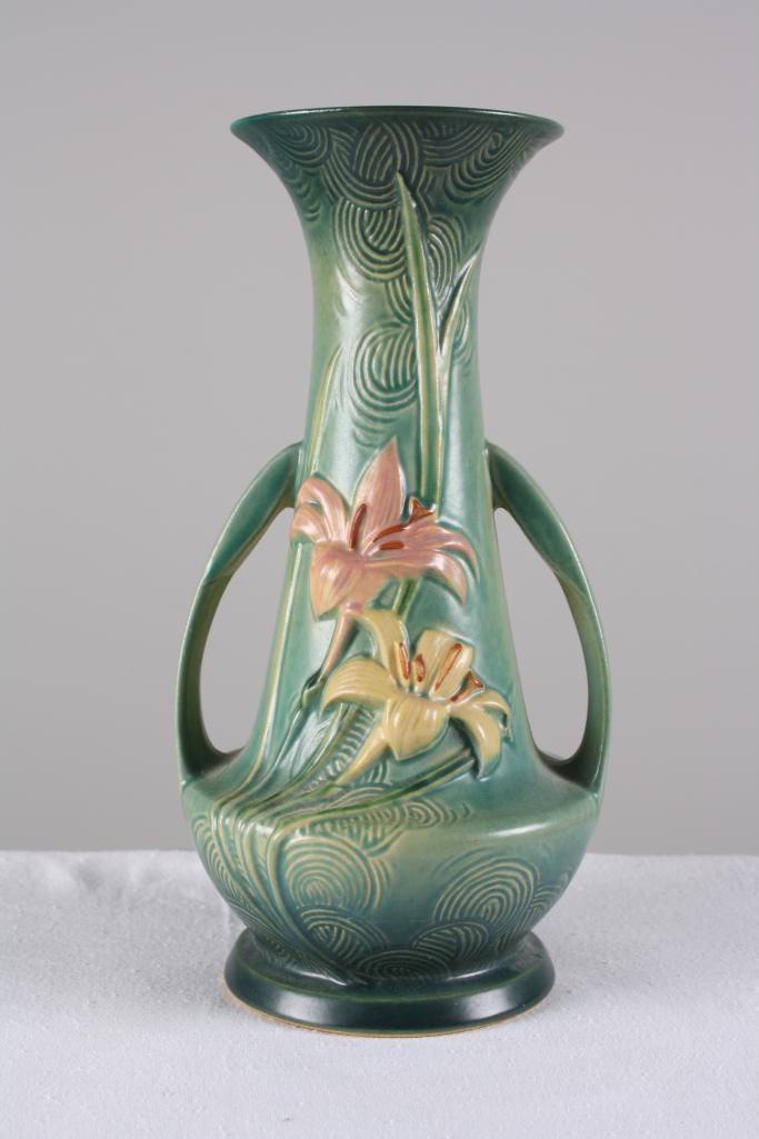 Roseville Pottery Zephyr Lily Handled Vase: Green ground, marked 140-12. Dimensions: H 12.5 x W 7 x D 7 inches NOTE: No evidence of cracks, chips or repairs