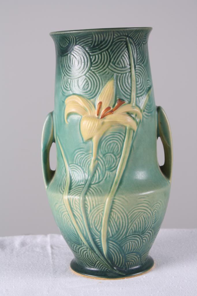 Roseville Pottery Zephyr Lily Handled Vase: Green ground, marked 138-10. Dimensions: H 10.5 x W 6 x D 6 inches NOTE: No evidence of cracks, chips or repairs