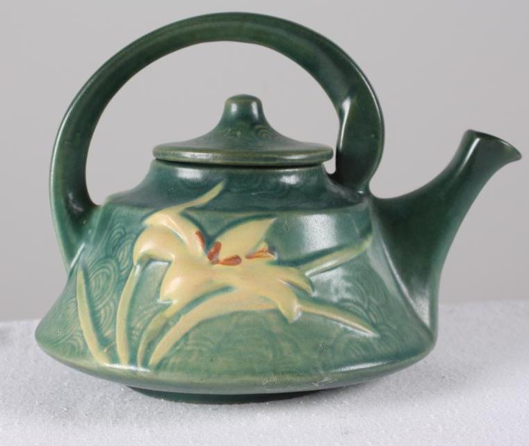 Roseville Pottery Zephyr Lily Teapot: Green ground, marked 7-7 Dimensions: H 7 x W 9.5 x D 7 inches NOTE: No evidence of cracks, chips or repairs