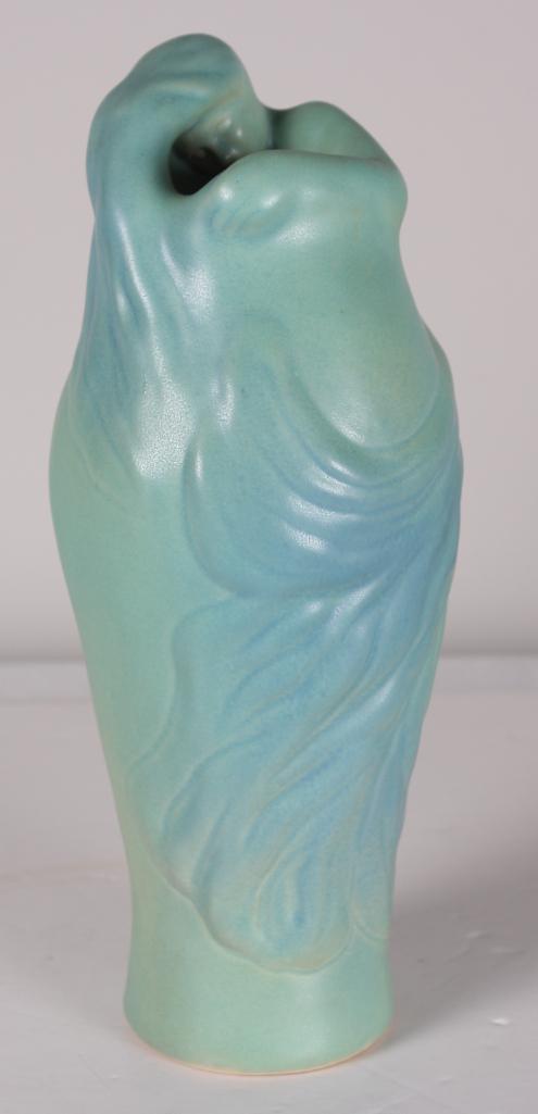 Van Briggle Pottery Art Nouveau Vase: The figure of the lady wraps around and blends into the green form of the vase. Signed and marked on base Dimensions: H 11 x W 5 x D 5 inches NOTE: No apparent chips, cracks or repairs