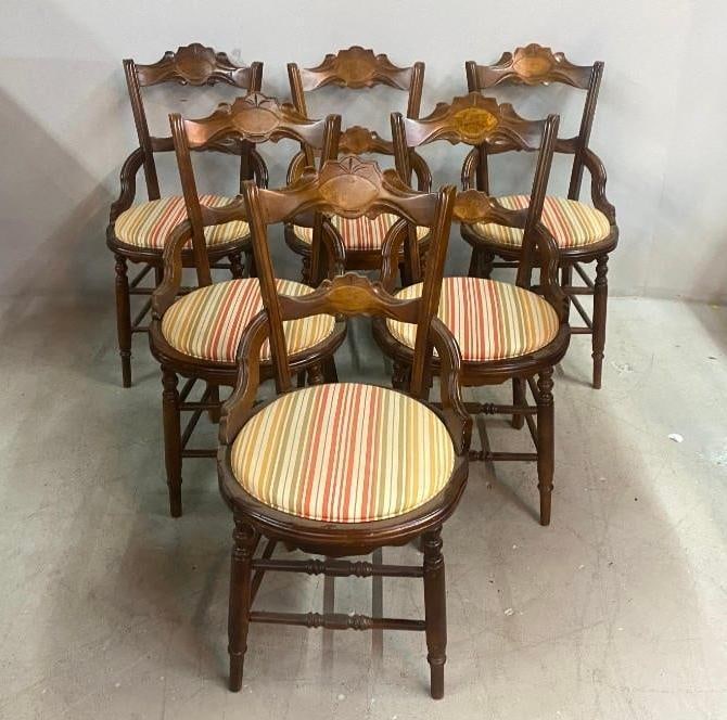 Six Eastlake Dining Chairs: Each with a carved crestrail over a single horizontal splat over a round upholstered seat , the whole raised on four turned legs supported no turned stretchers Dimensions: 35 x 18 x 17 in. NOTE: