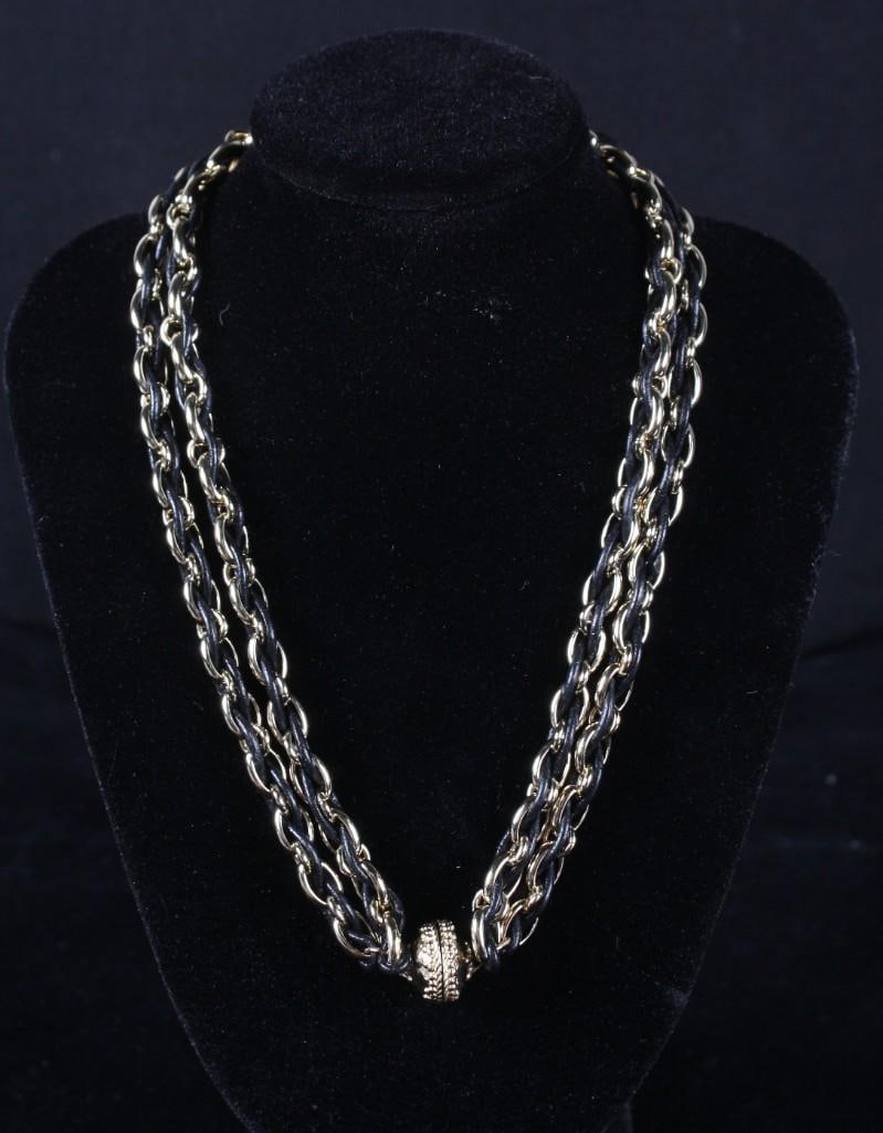 Claire Williams Necklace: Gold and leather intertwined chain with gold magnetic accents Dimensions: H 16 x W x D inches NOTE: Excellent Condition