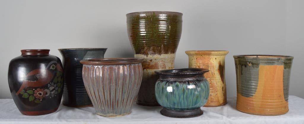 Seven Earthenware planters: Measurements for LargestDimensions: H 19.75 x W 12.75 x D 12.75 inchesNOTE: Some nicks to surface